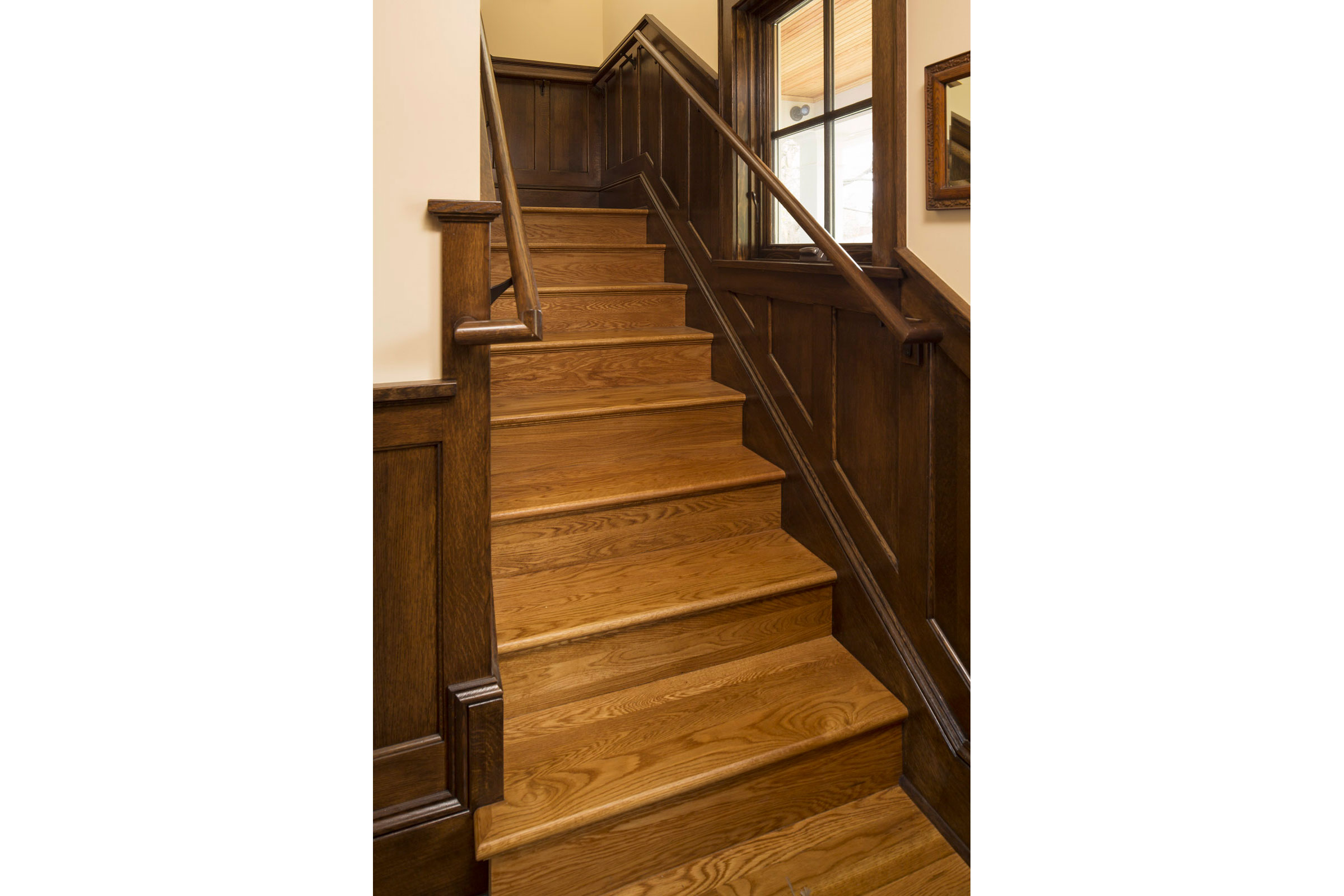 Stair Wrapping Around Elevator with Quartersawn Oak Wainscoting